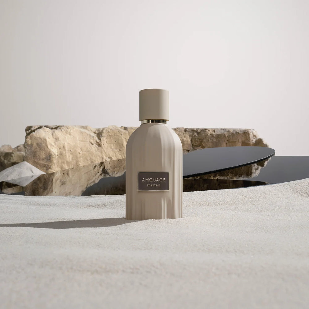 Amouage Reasons bottle in sand
