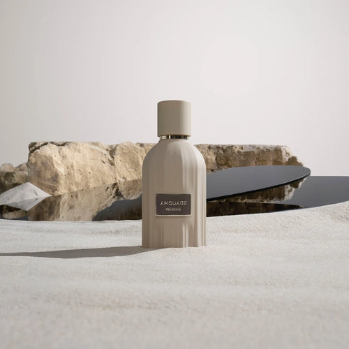 Amouage Reasons bottle in sand