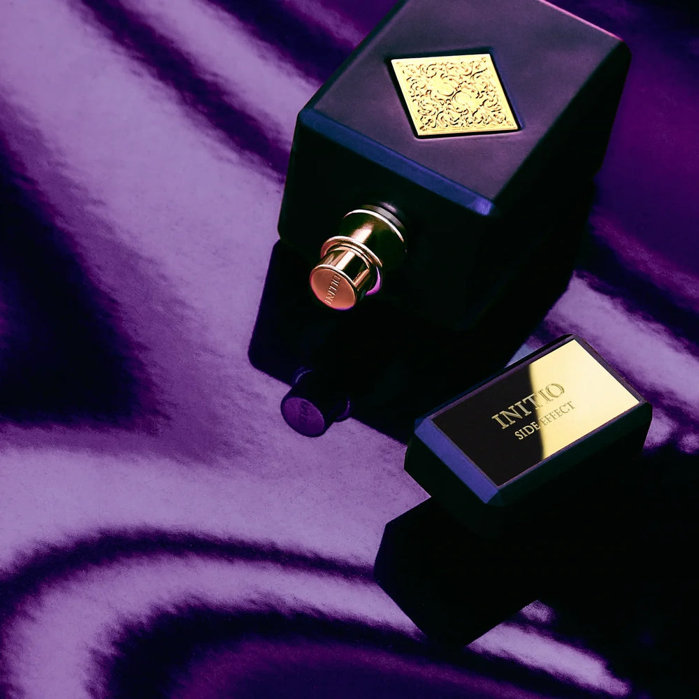 Initio Side Effect bottle on purple silk — lifestyle
