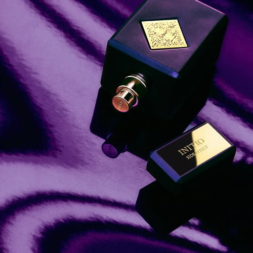 Initio Side Effect bottle on purple silk — lifestyle